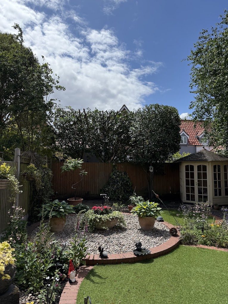 A tidy, well-kept garden after tree work with pruned shrubs and clear paths.